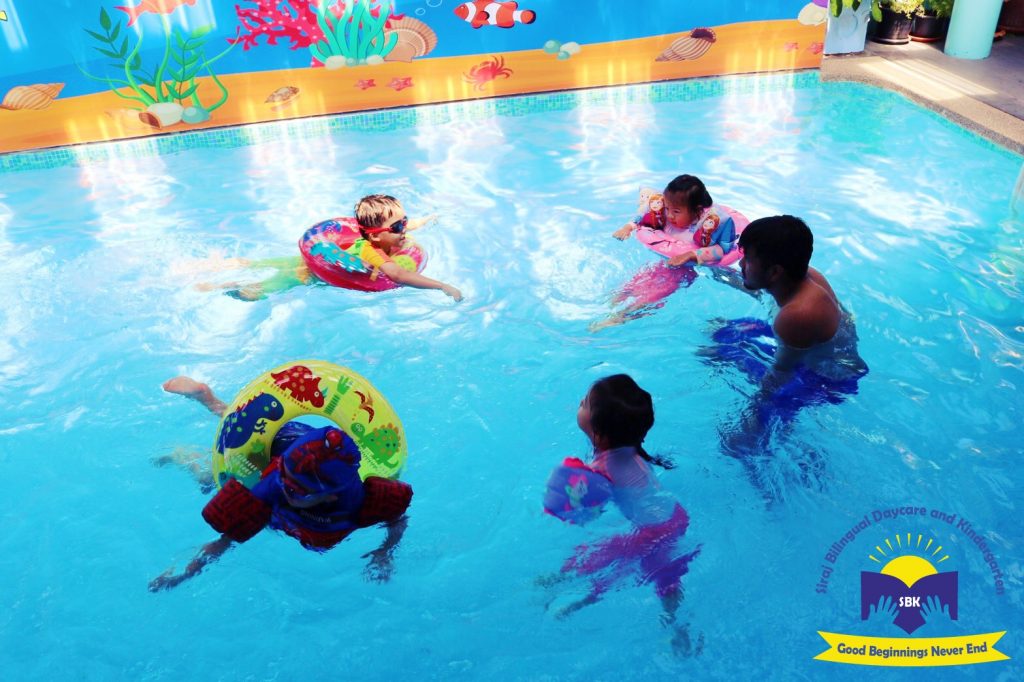 A Group Of SBK Students In A Circle In The Swimming Pool